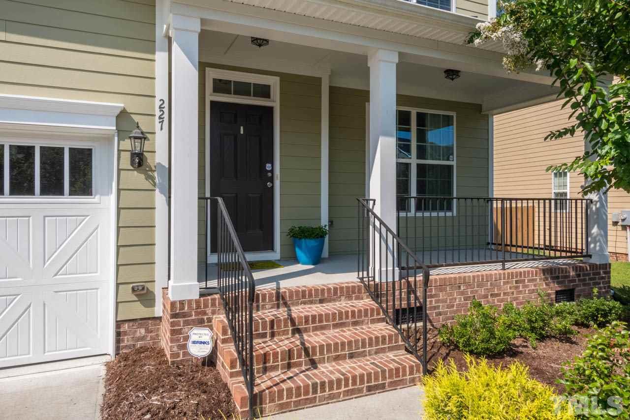 227 Strolling Way Durham, NC 27707 - Photo 2 of 25 a front view of a house with a porch