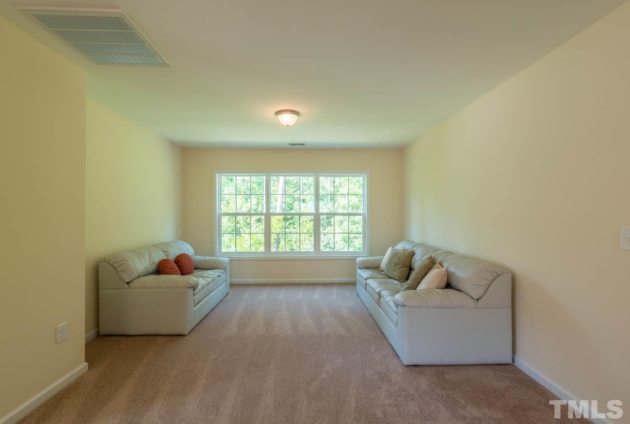 227 Strolling Way Durham, NC 27707 - Photo 21 of 25 a living room with furniture and a window