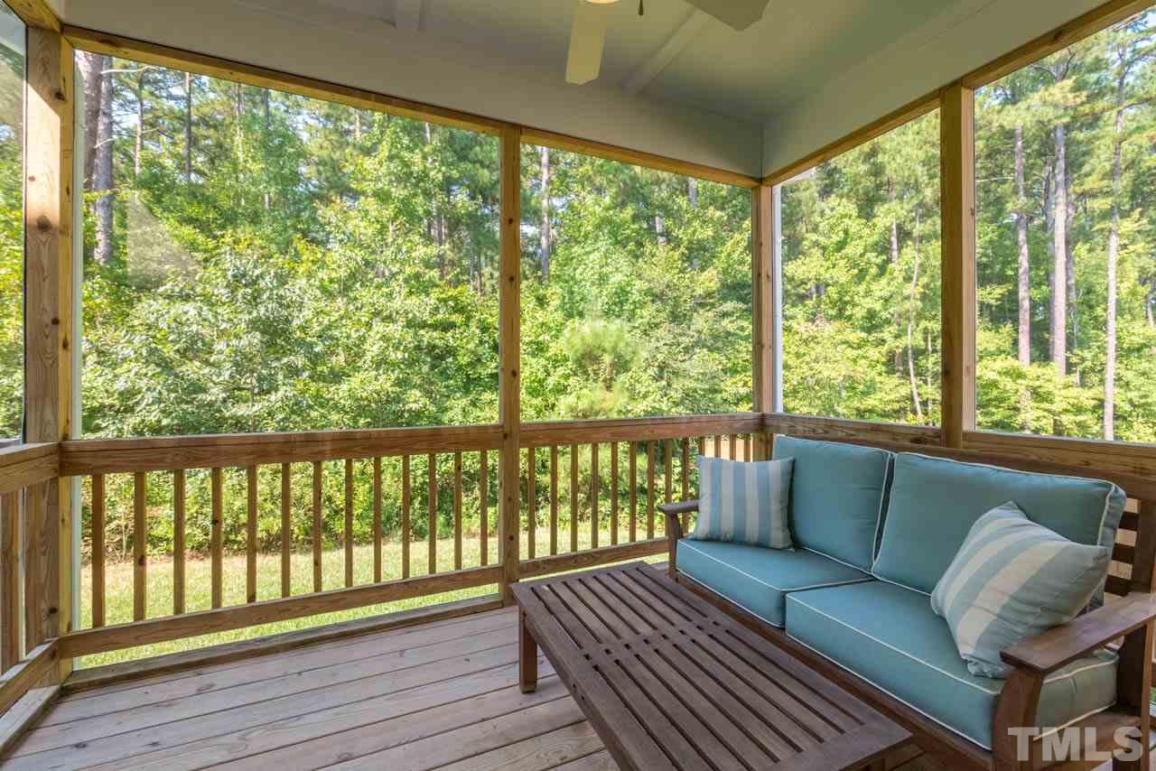 227 Strolling Way Durham, NC 27707 - Photo 23 of 25 a living room with wooden floor and a bed