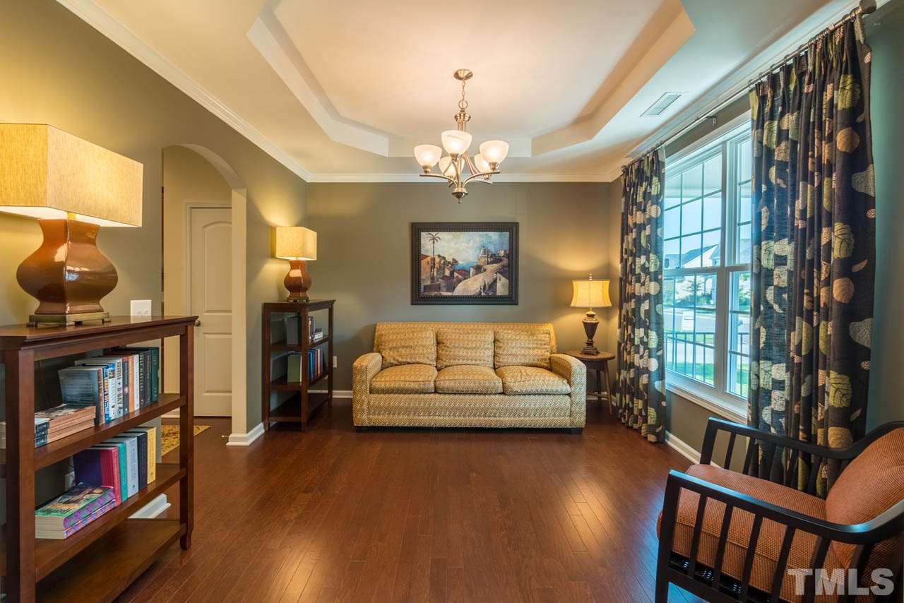 227 Strolling Way Durham, NC 27707 - Photo 4 of 25 a bedroom with furniture and a book shelf