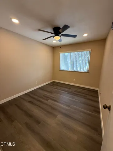 a view of a room with wooden floor