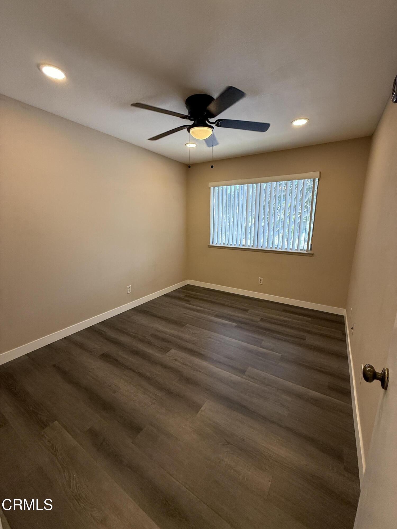 2690 Anchor Avenue Port Hueneme, CA 93041 - Photo 12 of 22 an empty room with wooden floor ceiling fan and window