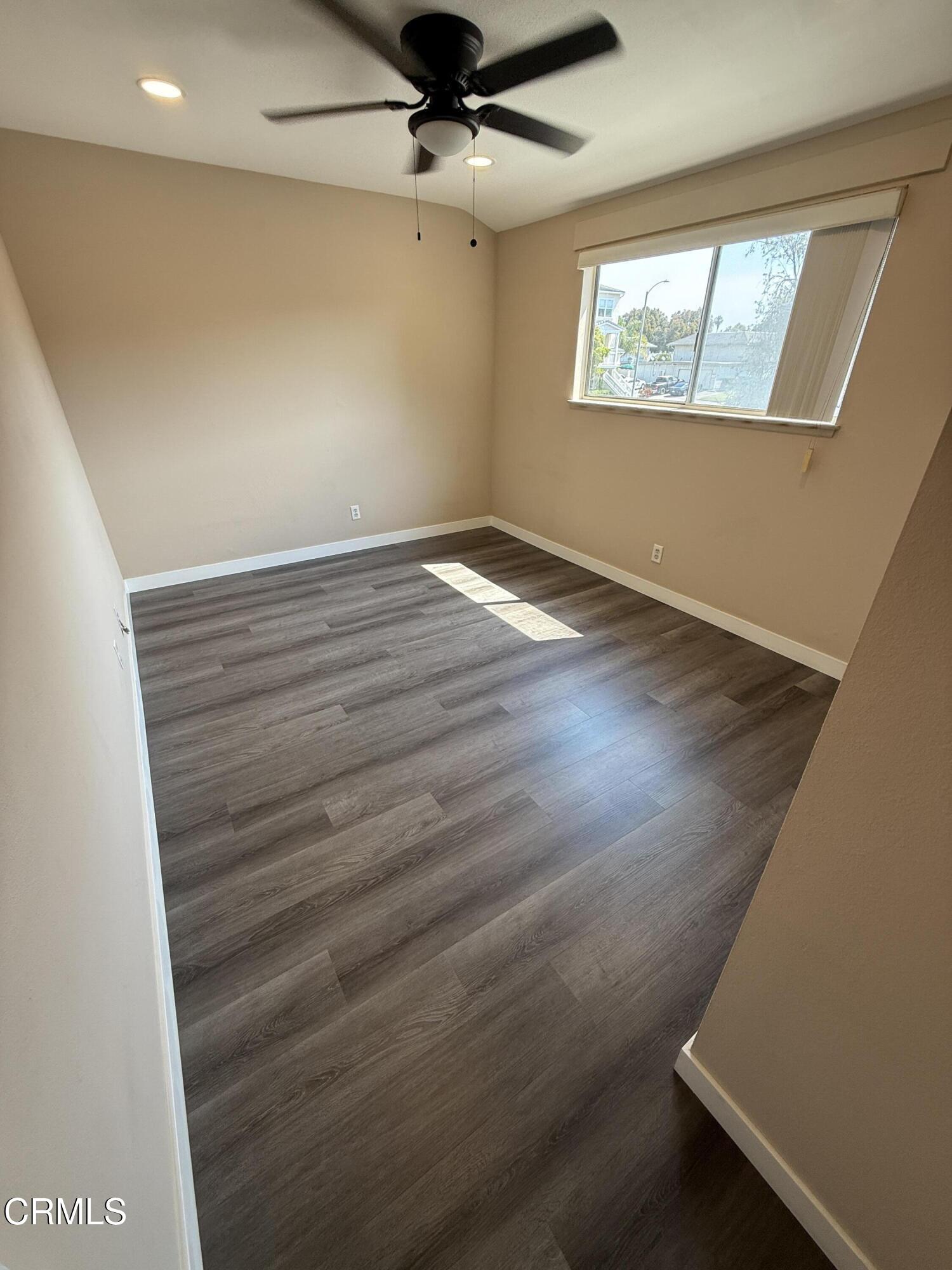 2690 Anchor Avenue Port Hueneme, CA 93041 - Photo 17 of 22 an empty room with wooden floor fan and windows