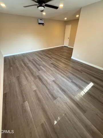 a view of a kitchen with wooden floor and electronic appliances