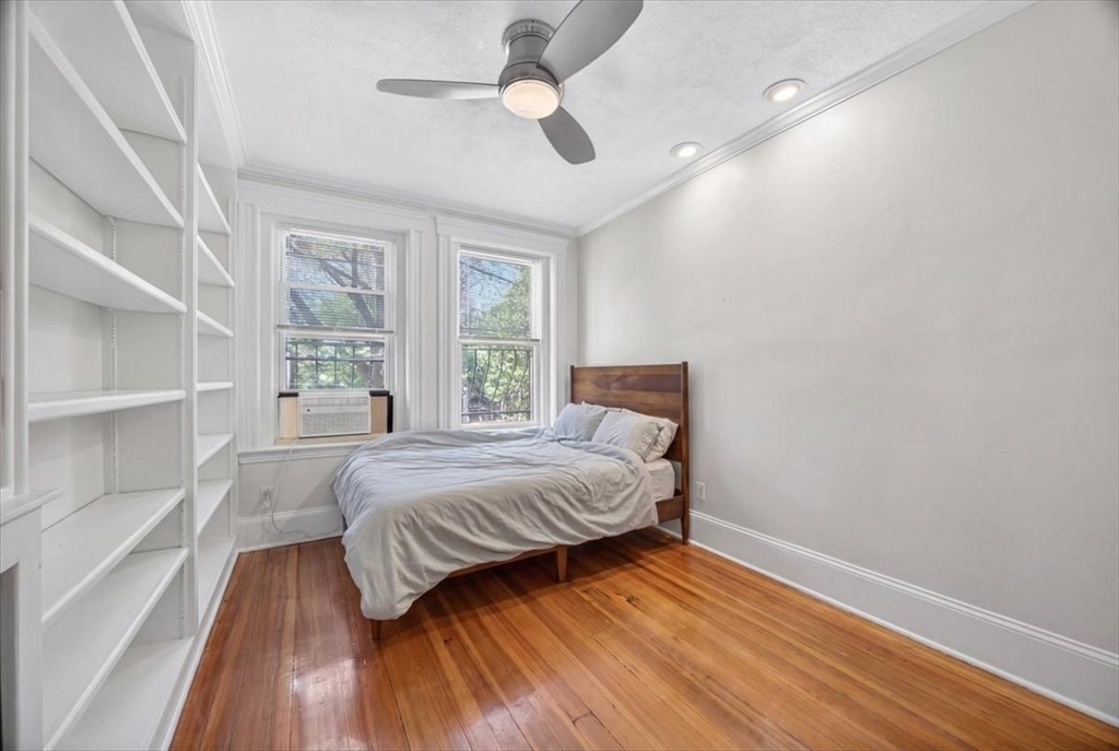 23 Netherlands Road, Unit 1 Brookline, MA 02445 - Photo 13 of 35 a bedroom with a bed and wooden floor