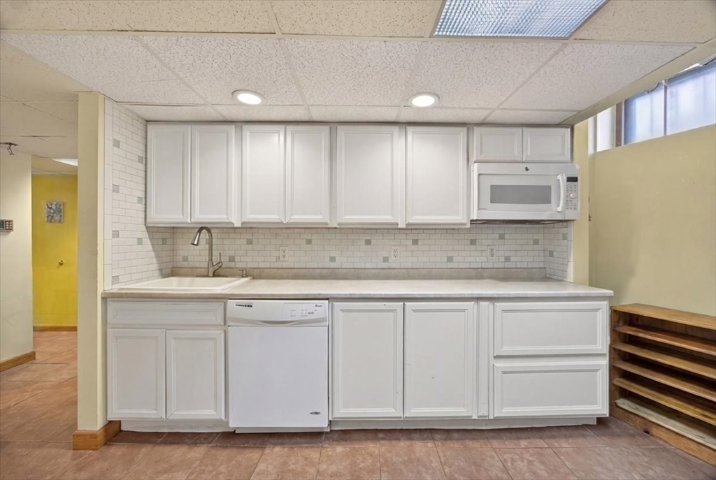 23 Netherlands Road, Unit 1 Brookline, MA 02445 - Photo 18 of 35 a kitchen with stainless steel appliances granite countertop a sink and cabinets