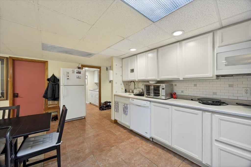 23 Netherlands Road, Unit 1 Brookline, MA 02445 - Photo 19 of 35 a kitchen with stainless steel appliances granite countertop a refrigerator sink and cabinets