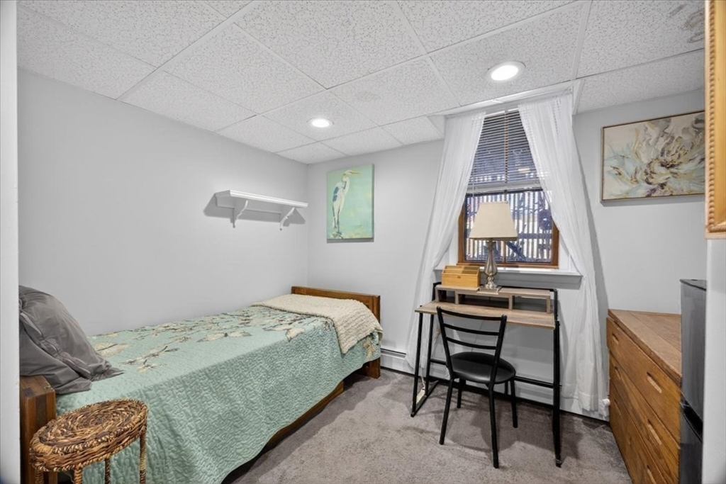 23 Netherlands Road, Unit 1 Brookline, MA 02445 - Photo 23 of 35 a bedroom with a bed and a workspace
