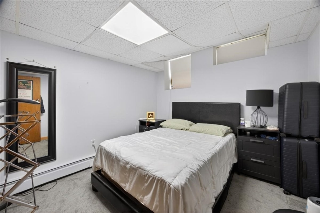 23 Netherlands Road, Unit 1 Brookline, MA 02445 - Photo 25 of 35 a bedroom with a bed and dresser