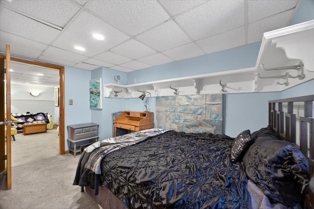23 Netherlands Road, Unit 1 Brookline, MA 02445 - Photo 27 of 35 a bed room with a bed and a chair