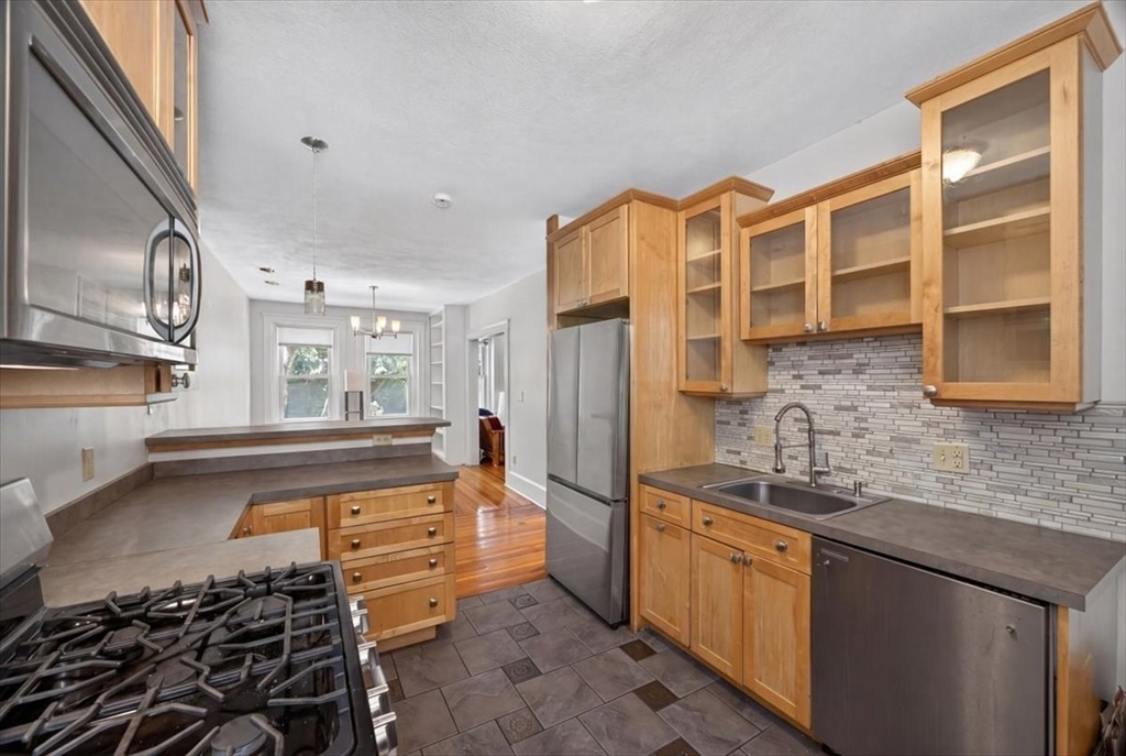 23 Netherlands Road, Unit 1 Brookline, MA 02445 - Photo 4 of 35 a kitchen with granite countertop a sink and cabinets