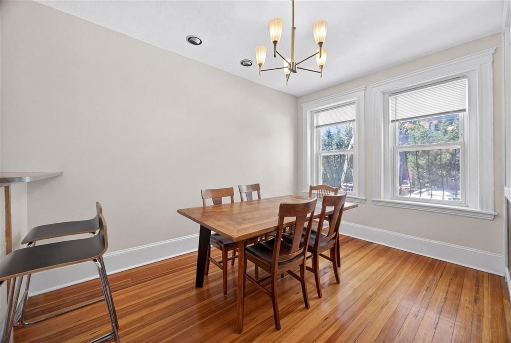 23 Netherlands Road, Unit 1 Brookline, MA 02445 - Photo 5 of 35 a view of a dining room with furniture wooden floor and chandelier