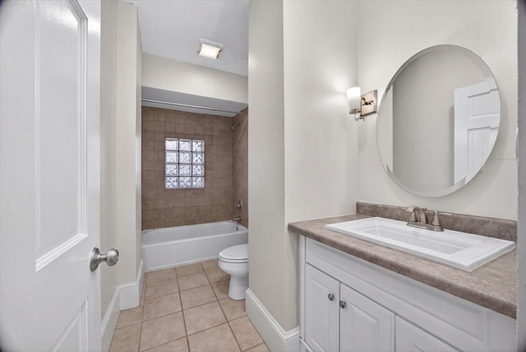 23 Netherlands Road, Unit 1 Brookline, MA 02445 - Photo 8 of 35 a bathroom with a sink a toilet and a bathtub