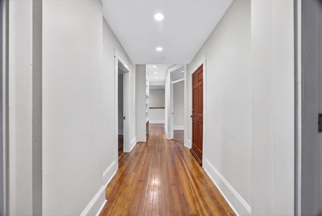 23 Netherlands Road, Unit 1 Brookline, MA 02445 - Photo 9 of 35 a view of hallway with wooden floor