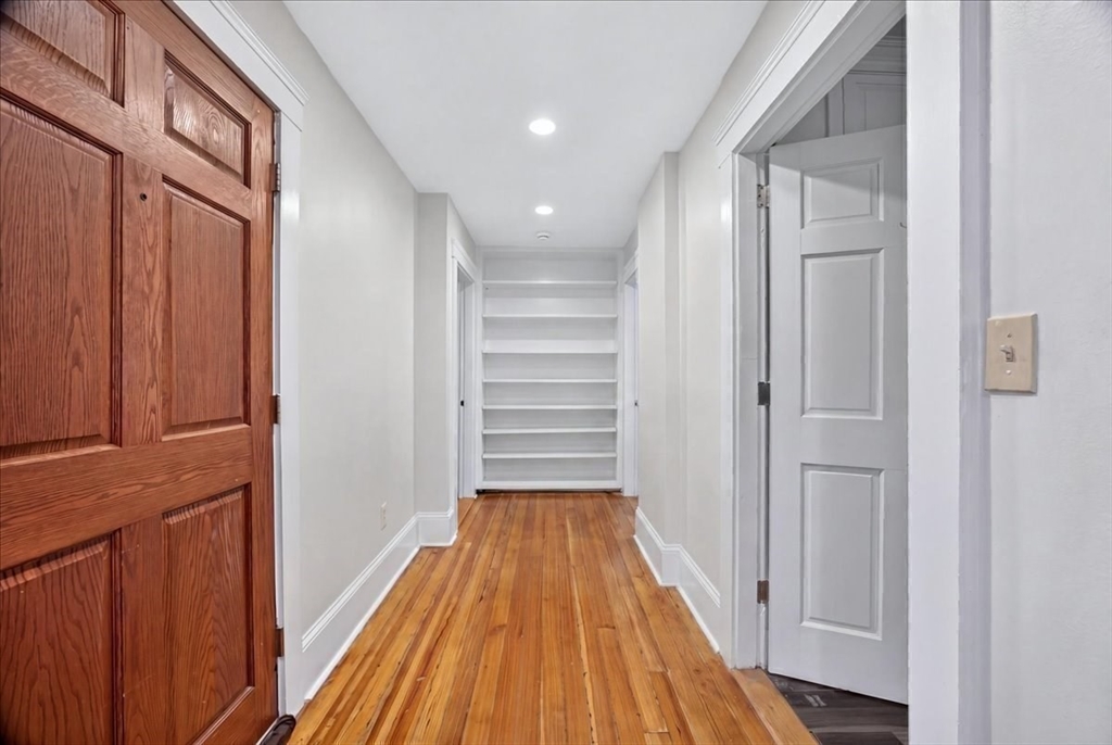 23 Netherlands Road, Unit 1 Brookline, MA 02445 - Photo 10 of 35 a view of a hallway with wooden floor and staircase