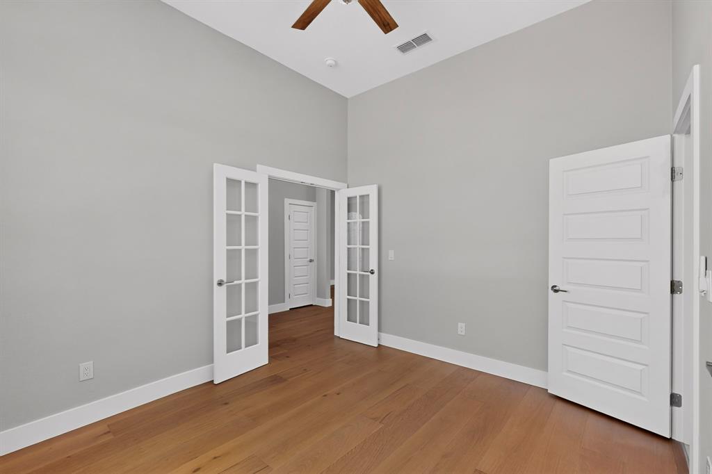 108 Winding Way Azle, TX 76020 - Photo 29 of 38 Vaulted ceilings, wood-finish flooring, French doors, contemporary paneled door, and a ceiling fan