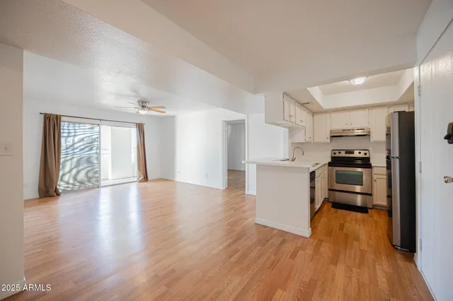a view of kitchen with wooden floor electronic appliances and window