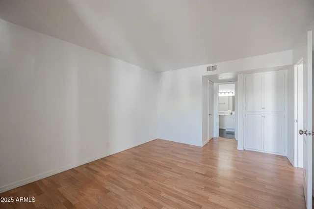 a view of wooden floor and windows in a room