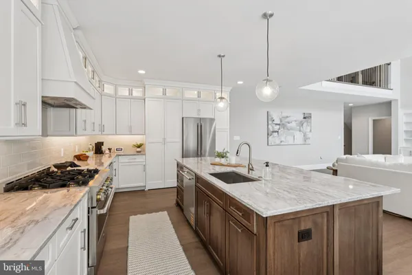 a kitchen that has a lot of cabinets a sink and a stove
