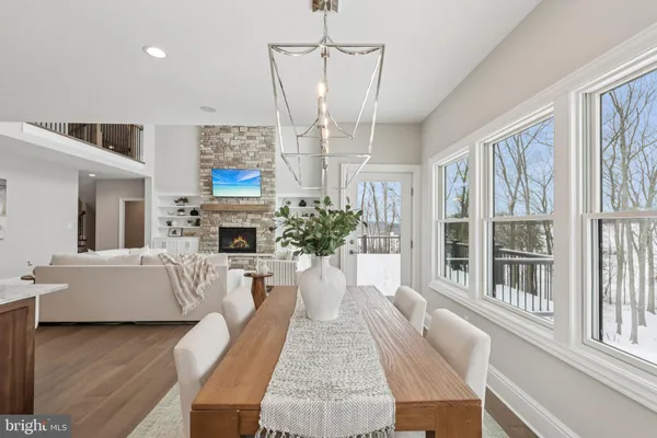 a living room with fireplace furniture and a chandelier