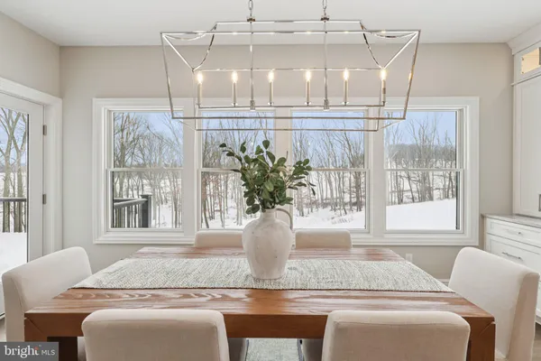 a view of a dining room with furniture and a window