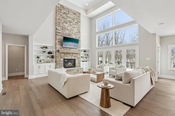 a living room with fireplace furniture and a large window
