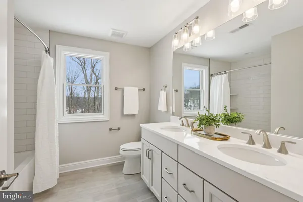 a bathroom with a sink double vanity and a mirror