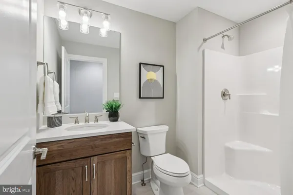 a bathroom with a granite countertop bathtub shower and a toilet