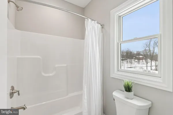a living room with furniture and a lamp with rug