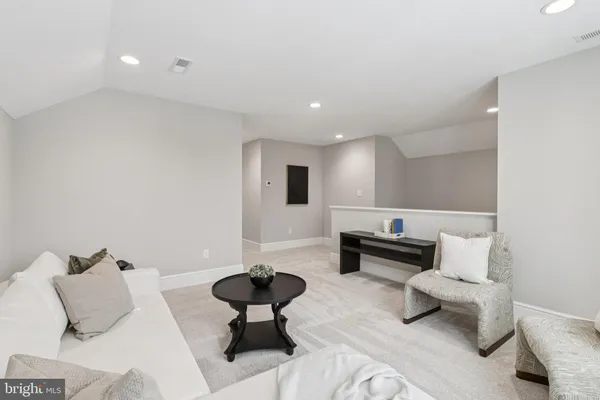 a bathroom with a shower sink vanity mirror and toilet