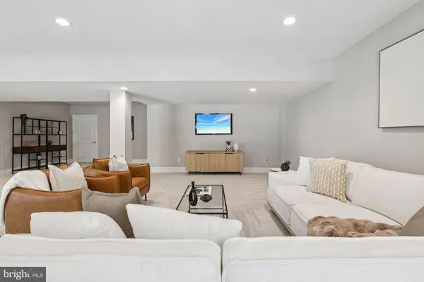 a bathroom with a sink a toilet a mirror a vanity a bathtub and shower