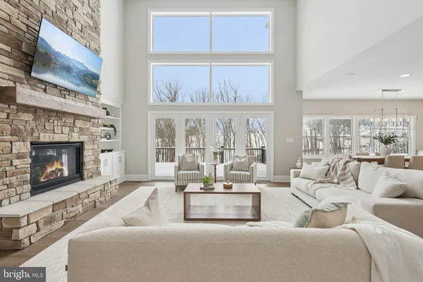 a living room with furniture large window and a fireplace