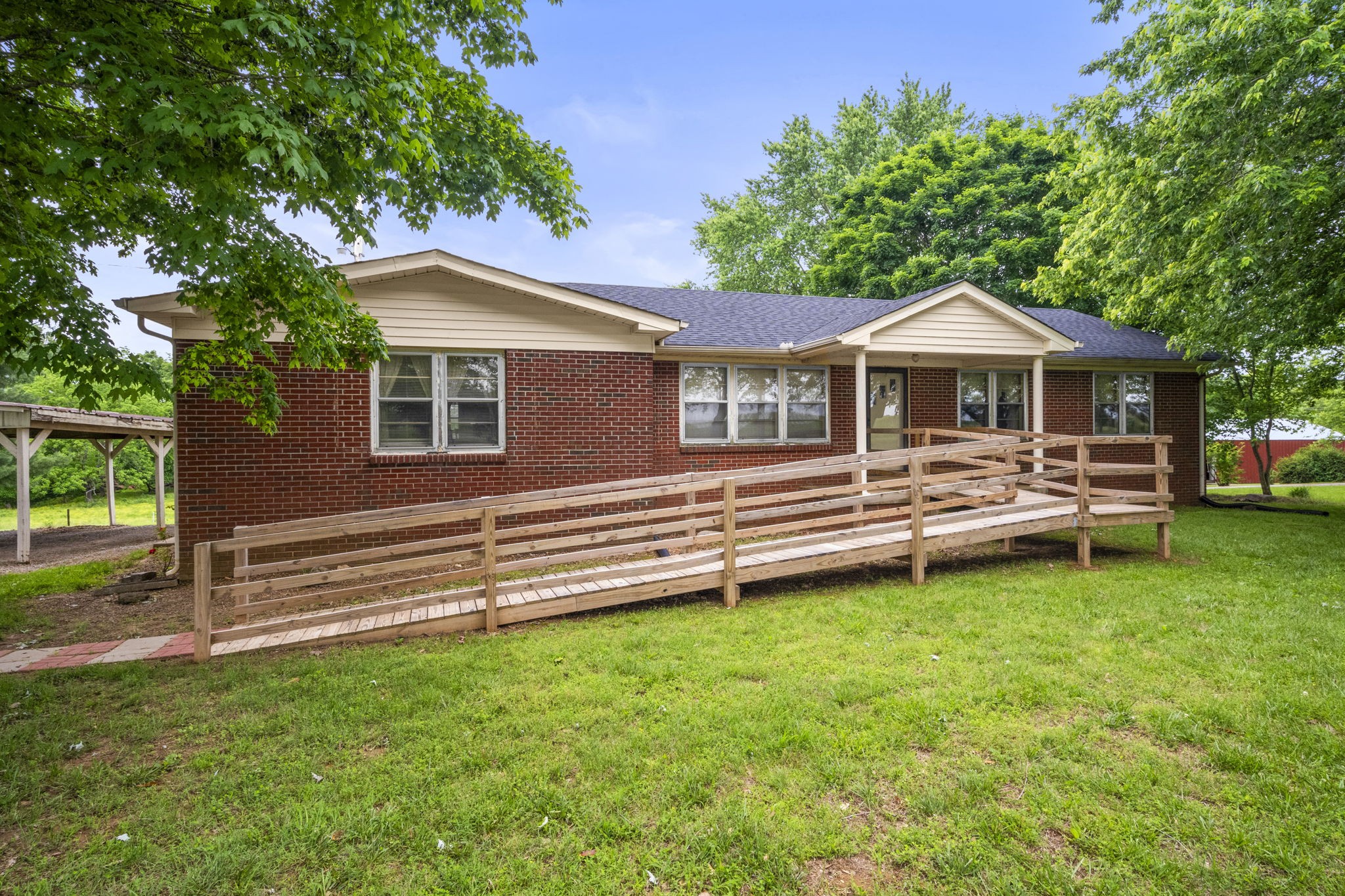 5125 Rippy Road Cross Plains, TN 37049 - Photo 6 of 34 a front view of a house with a garden and trees