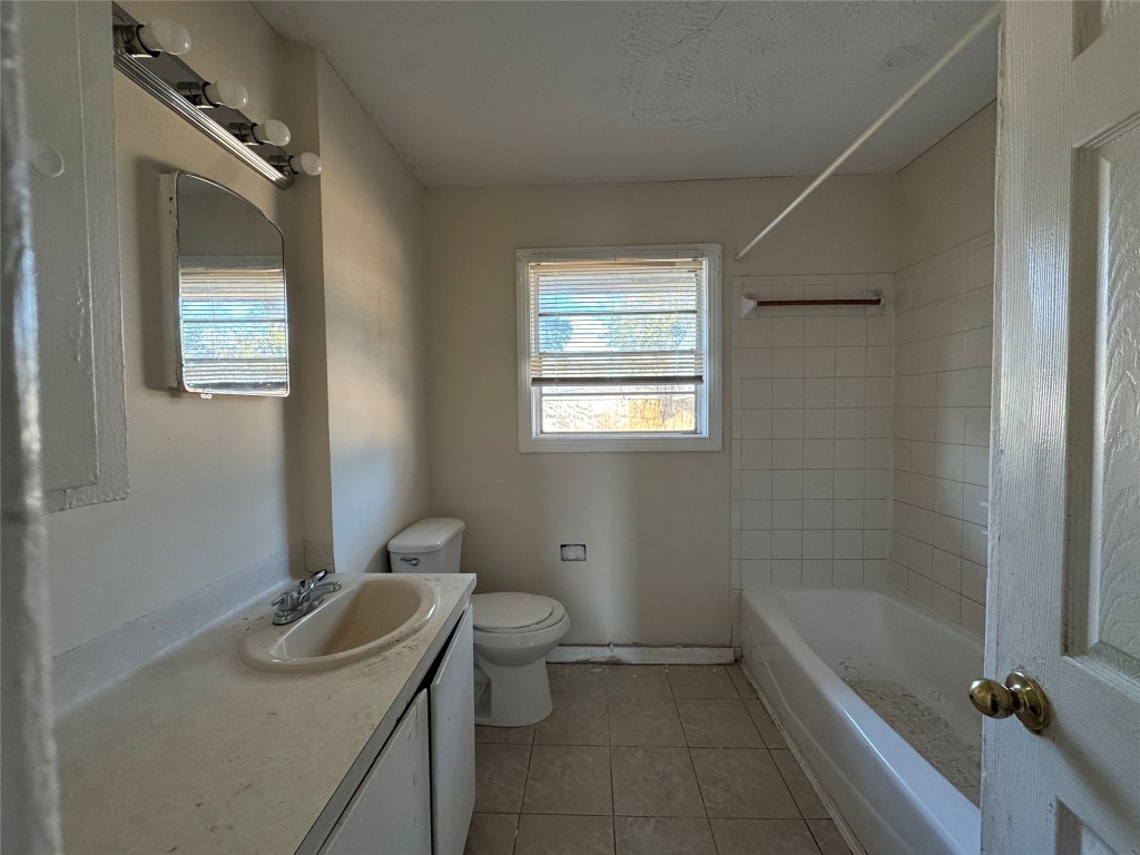 8719 Tilgham Street Houston, TX 77029 - Photo 8 of 11 a bathroom with a sink toilet and shower