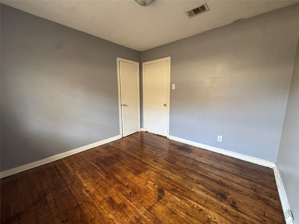 8719 Tilgham Street Houston, TX 77029 - Photo 9 of 11 a view of empty room with wooden floor