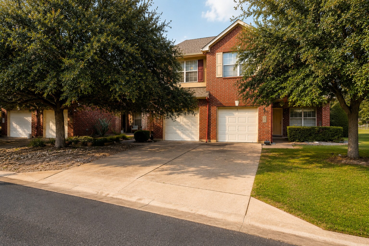 46 Verde Ranch Loop Leander, TX 78641 - Photo 2 of 19 A classic brick exterior, framed by mature trees, provides an inviting curb appeal.