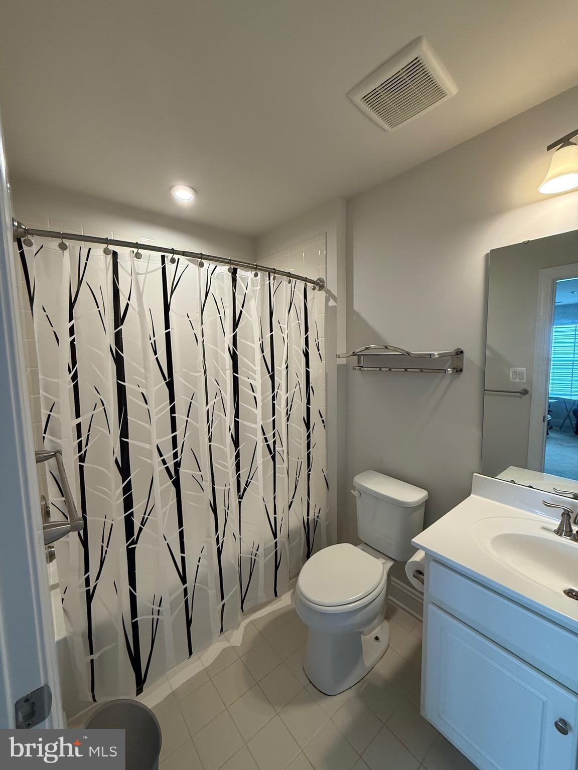 3148 Sunny Ridge Drive Odenton, MD 21113 - Photo 20 of 32 a bathroom with a toilet sink and shower curtain