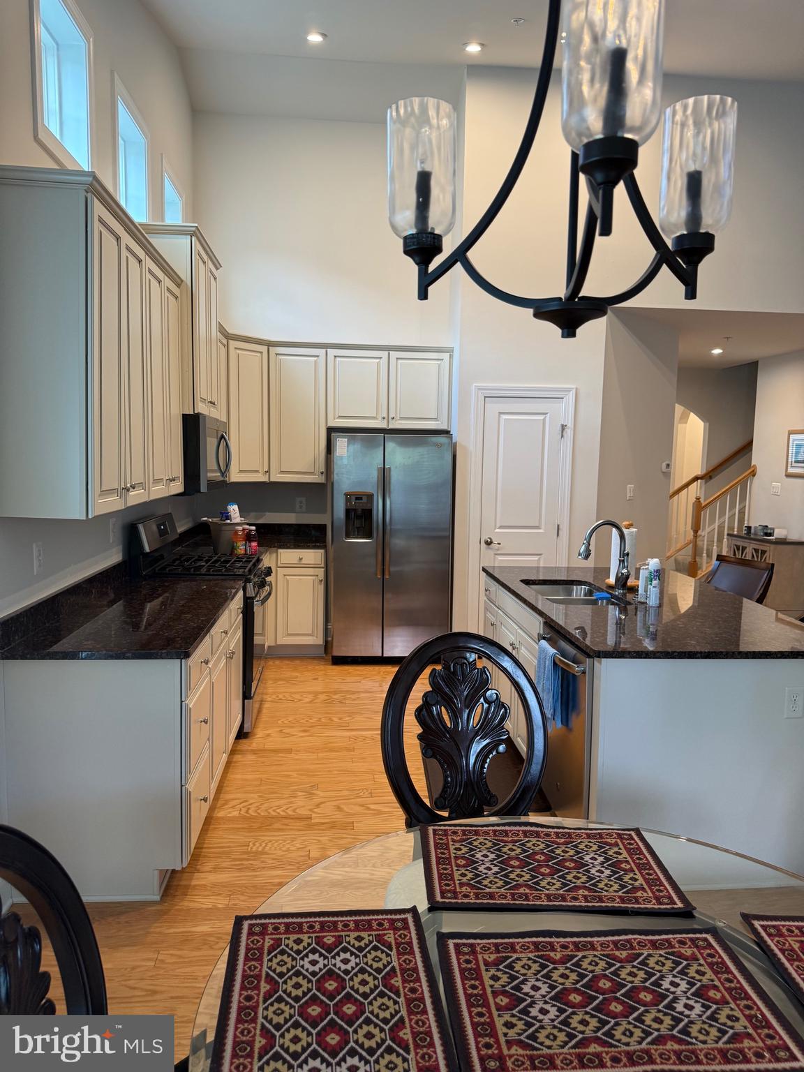 3148 Sunny Ridge Drive Odenton, MD 21113 - Photo 23 of 32 a kitchen with kitchen island granite countertop a stove a sink and a refrigerator