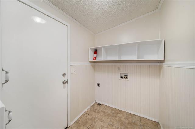 15 Sun Prairie Road Pryor, OK 74361 - Photo 20 of 34 Utility space featuring built-in shelving located off the kitchen & garage