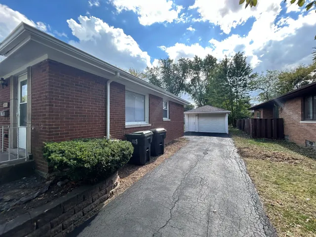 a view of a house with a yard and a garden