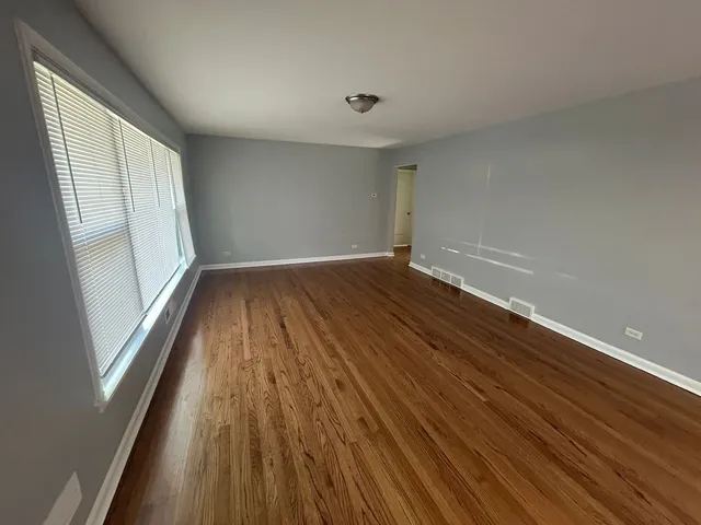 a view of wooden floor and brick walls