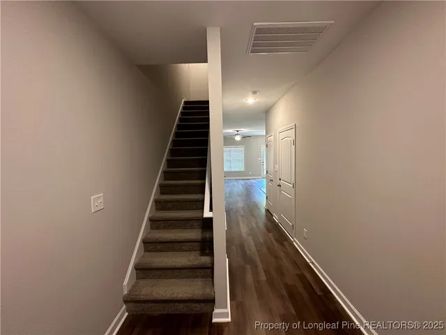 a view of entryway and hall with wooden floor