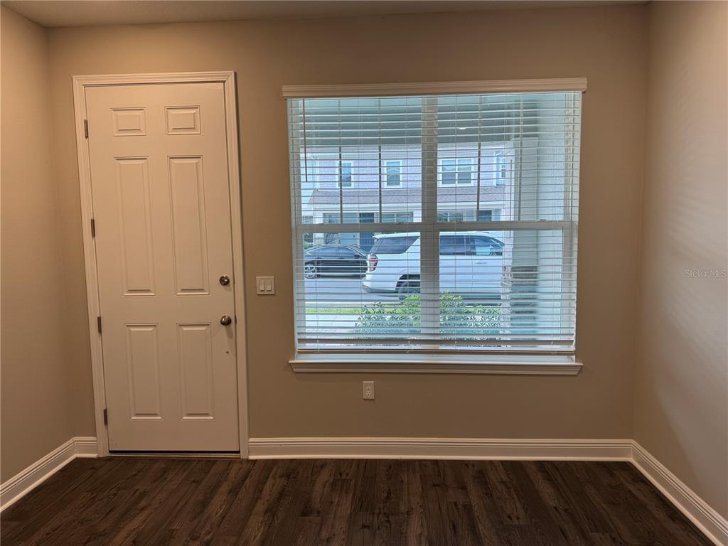 16434 Hamlin Hills Road Winter Garden, FL 34787 - Photo 4 of 50 an empty room with wooden floor and windows