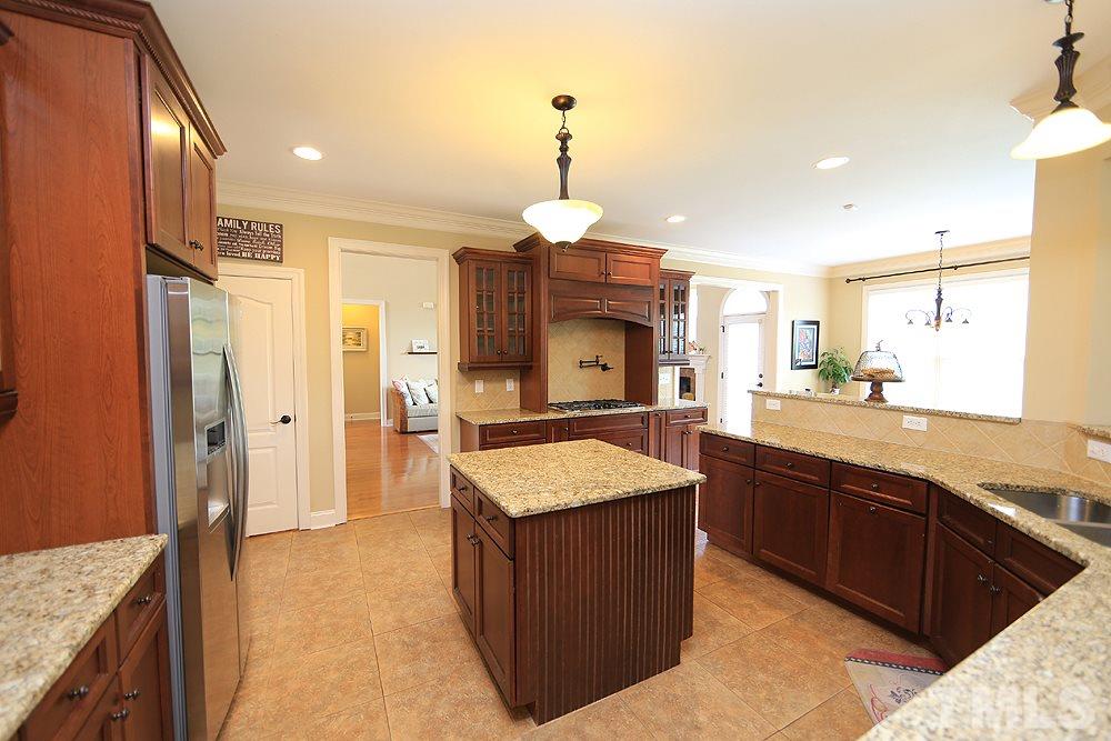 637 Competition Road Raleigh, NC 27603 - Photo 16 of 30 View of the kitchen as you enter in from the garage. From this view you get another feeling for the size and layout. (And don't miss that pot filler over the stove. Love it!)