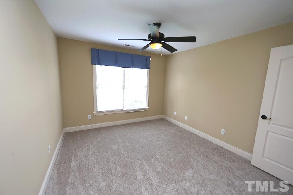 637 Competition Road Raleigh, NC 27603 - Photo 23 of 30 The second of three upstairs bedrooms. Ceiling fans in all the bedrooms is an added bonus.