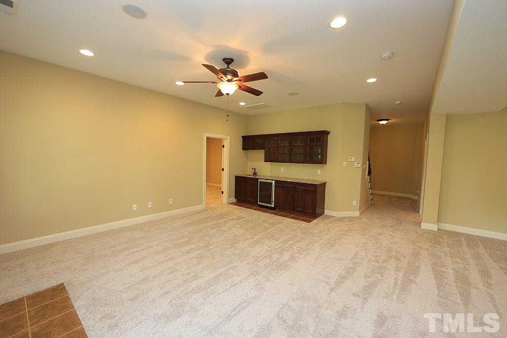 637 Competition Road Raleigh, NC 27603 - Photo 28 of 30 View from the Patio Doors looking back at the cabinets, sink and built in fridge. Not pictured is a separate office space and full bath and media room.