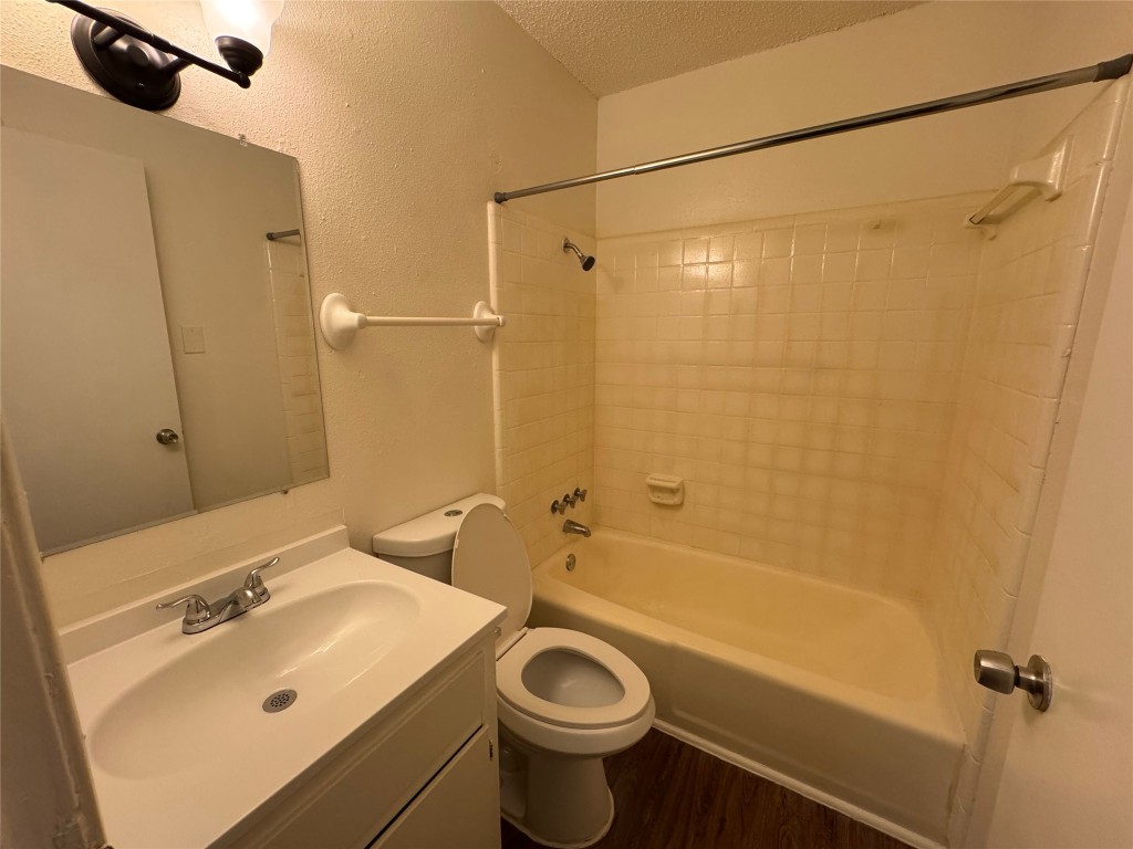4904 West Wind Trail, Unit 103 Austin, TX 78745 - Photo 12 of 22 a bathroom with a sink a toilet and shower