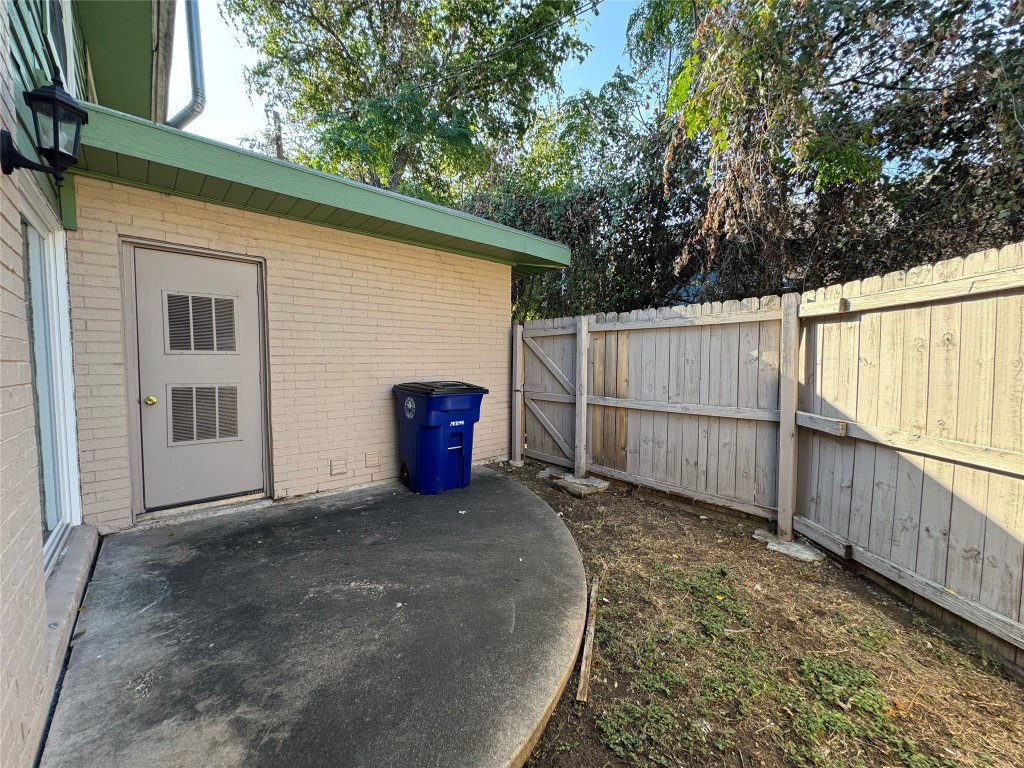 4904 West Wind Trail, Unit 103 Austin, TX 78745 - Photo 21 of 22 a view of a backyard with wooden fence and large trees