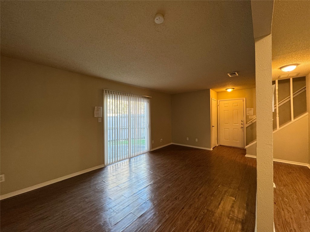 4904 West Wind Trail, Unit 103 Austin, TX 78745 - Photo 5 of 22 a view of an empty room with wooden floor and a window