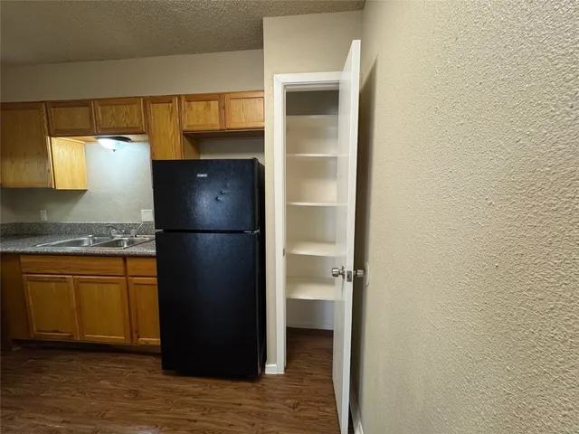 a kitchen with a refrigerator and cabinets